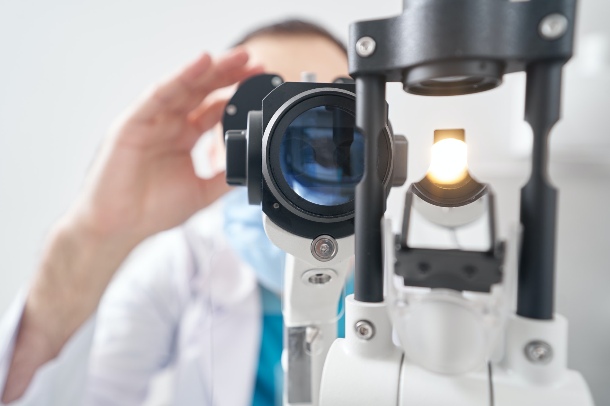 Ophthalmologist using medical equipment in the hospital